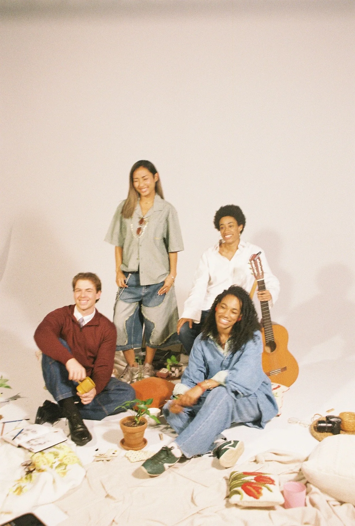 Four Idio teammates gathered in the studio with their creative supplies.
