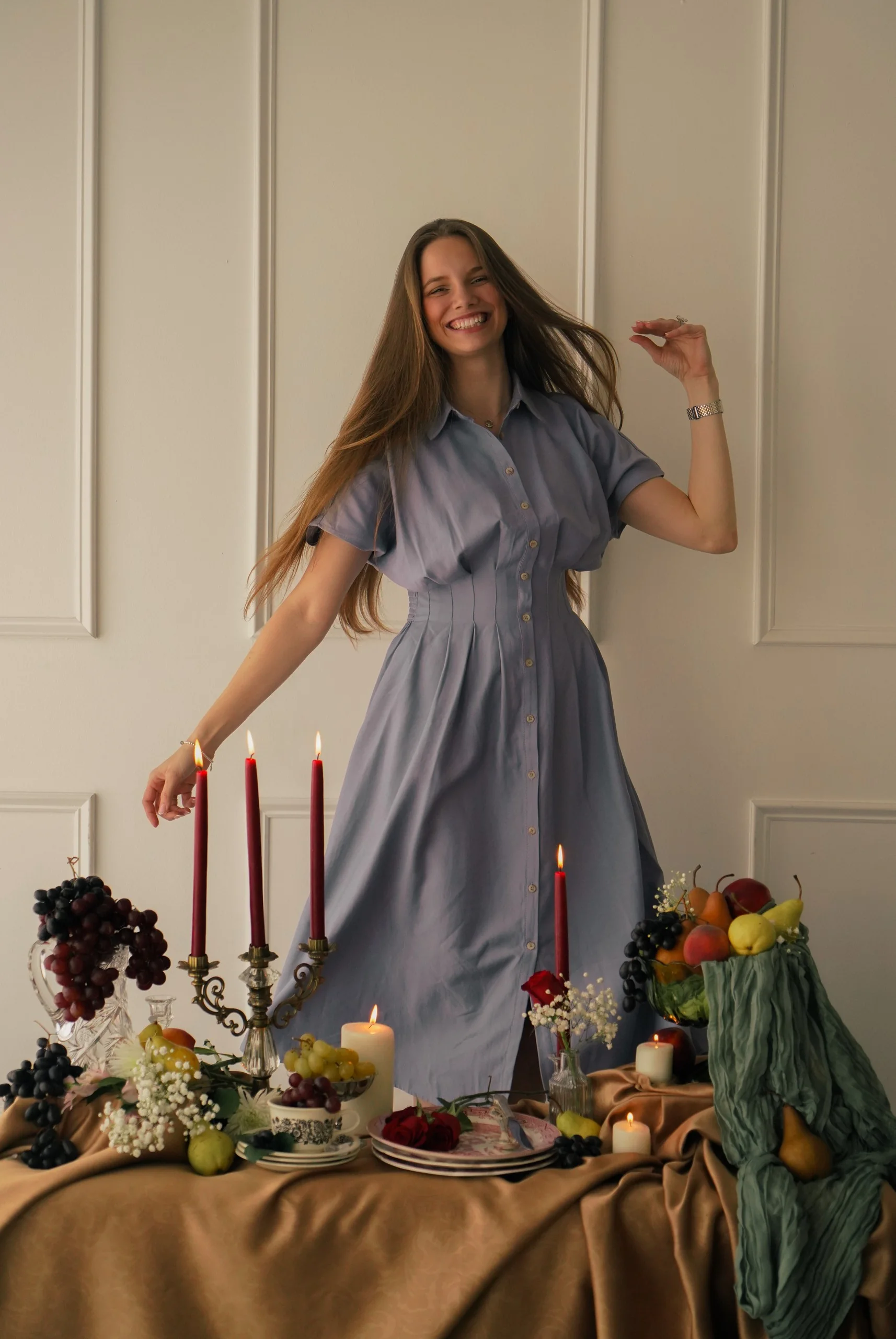 Woman in a blue dress behind a floral event table